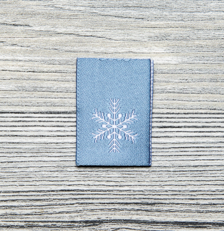 Webetiketten - Webetikett mit Mittelfaltung - 20mm x 55mm - Schneeflocke