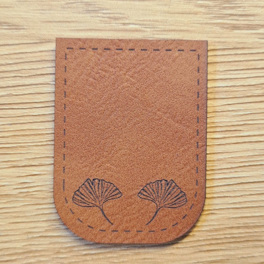 Braunes Kunstleder-Kordelende mit zwei Ginkgo-Blatt-Motiven, U-förmig zum Aufnähen, naturverbundenes Design für Kleidung und Accessoires, vegan, laser-graviert bei Schnuckidu